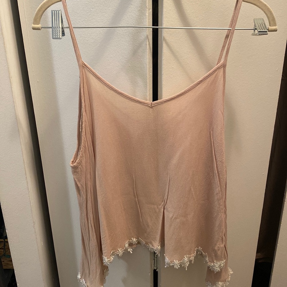 Selling a beige off the shoulder top with criss cross straps in the back.